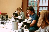 Forest Service personnel looking through microscopes at the lab.